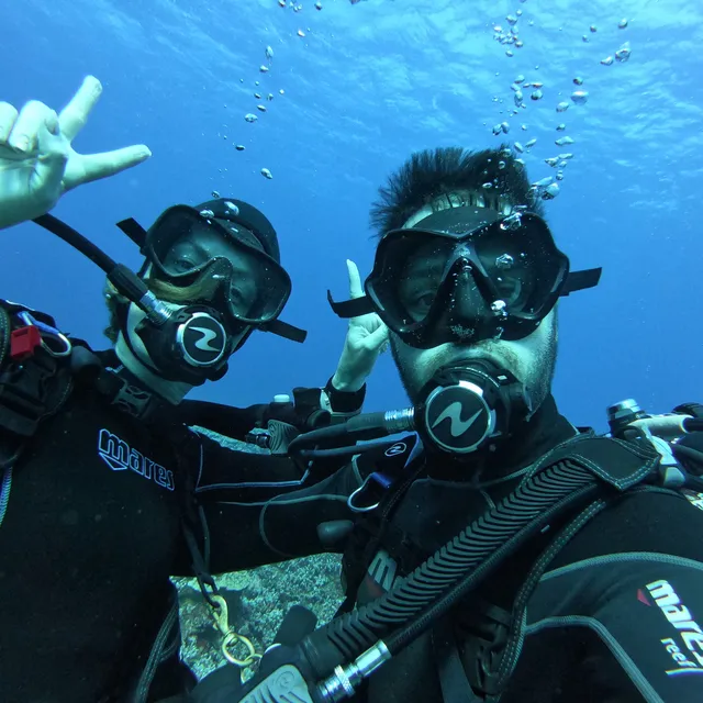 Jeff and a dive buddy underwater in masks and regulators